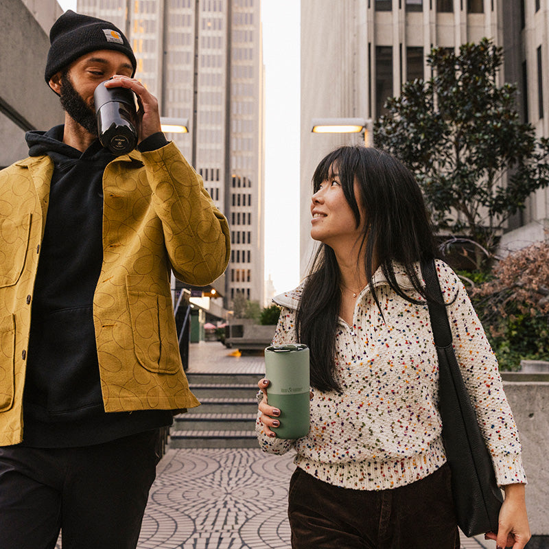 16oz-rise-tumbler-w1 16oz_rise_tumbler_black_iceberg_couple_drink_city_street_square.jpg