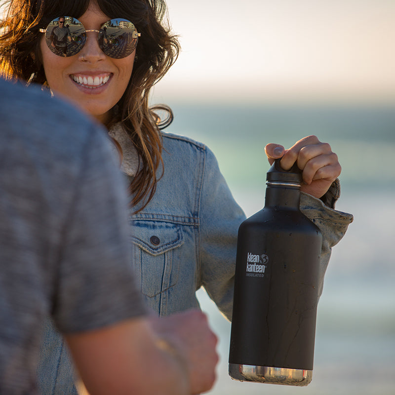 64oz-classic-with-loop-cap-q2 64oz_insulated_classic_black_beach_girl_hand_square.jpg