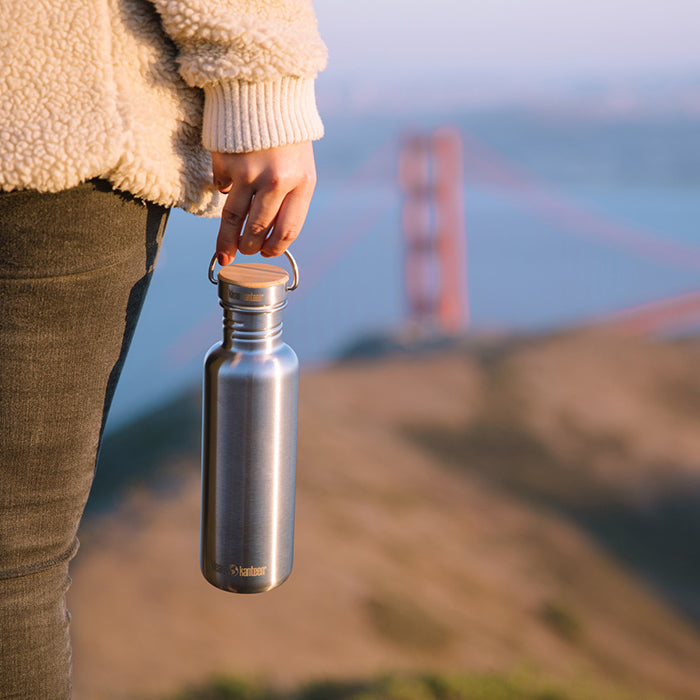 27oz-reflect-with-bamboo-cap-l8 K27SSLRF-BS-BAMBOO_reflect_bottle_bridge_lifestyle.jpg